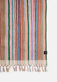 Multicolored striped textile featuring bold lines in red, blue, green, and yellow, with fringed edges and a small black label.