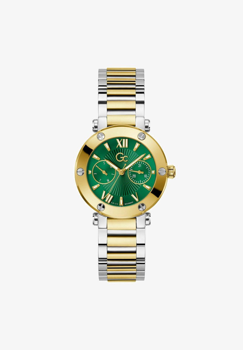 Reloj con esfera verde que presenta acentos en tono dorado, pulsera de eslabones de metal plateado y dorado, y números romanos en relieve en la esfera.