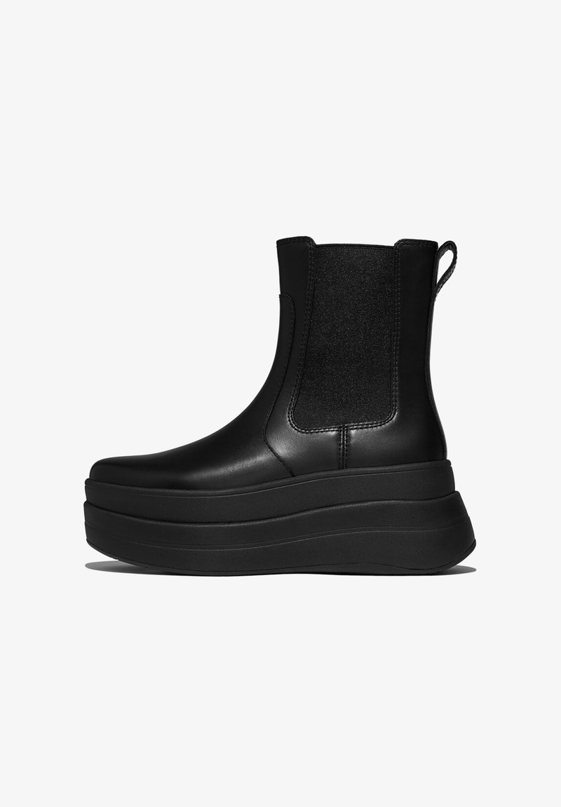 Black platform ankle boot made of smooth leather with elastic side panels, rounded toe, and a chunky rubber sole.