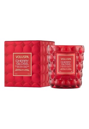 Rød kokosvokskande i tekstureret glas, sekskantet form med afrundede detaljer, mærket "Voluspa Cherry Gloss." Æsken har et matchende design.