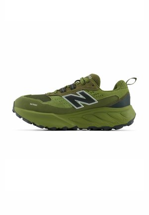 Scarpa da trail running verde con logo nero "N", suola spessa, materiali in mesh e camoscio, design con lacci e linguetta sul tallone.
