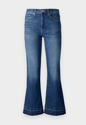 Høytlivede flagrende denimjeans i en mellomblå vask, med glidelås, beltehemper og samt frayed kant nederst.