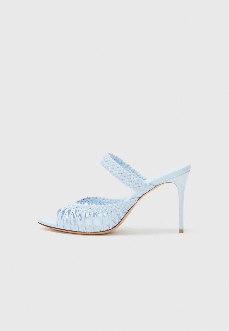 Light blue high-heeled sandal with a woven upper, open toe, and a wide strap across the foot. Smooth texture, slim stiletto heel.