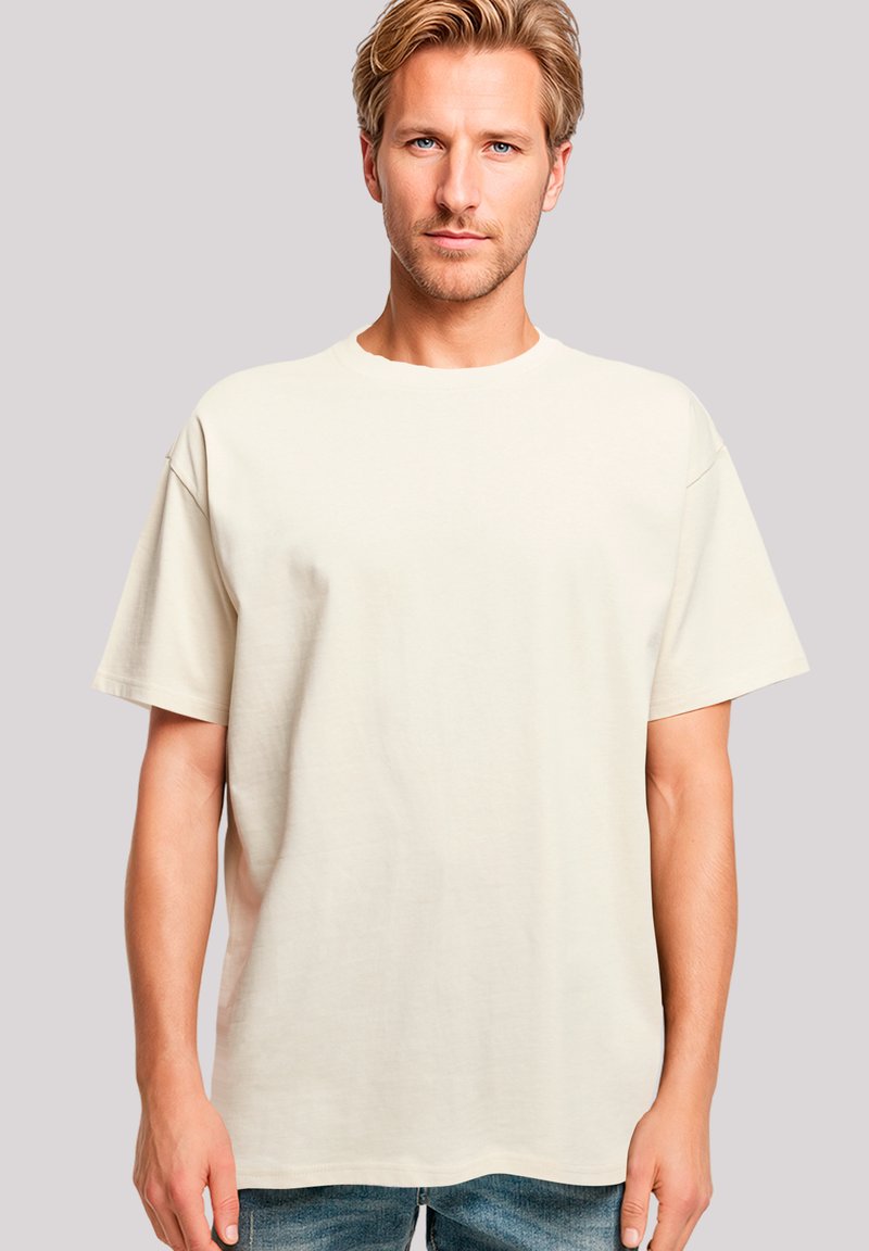 Beige short-sleeve T-shirt made of soft fabric. Relaxed fit with a round neckline and straight hem, showcasing a smooth texture.