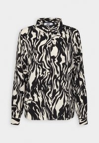 Blusa de manga larga en blanco y negro con un patrón abstracto ondulado, cierre de botones, cuello y un corte relajado, hecha de una tela ligera.