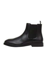 Stivale Chelsea in pelle nera con pannelli laterali elasticizzati, punta arrotondata e suola piatta in gomma. Dotato di una linguetta per una facile calzata.