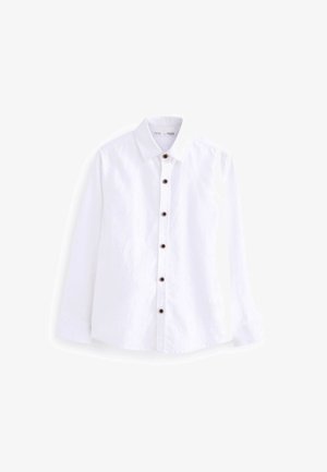 Chemise blanche à manches longues avec boutons foncés et col classique, présentée sur fond blanc.