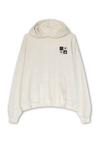 Sudadera de algodón, color crema, corte oversize. Cuenta con un bolsillo frontal y un parche gráfico con cuatro motivos de ojos en blanco y negro en el pecho.