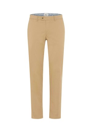 Beige bukser med lige ben, bæltestropper, knap- og lynlåslukning samt en blomstret inderkant på taljebåndet.