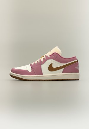 Sneaker basse con blocchi di colore rosa, bianco e marrone, con logo Nike marrone e lacci bianchi su sfondo neutro.