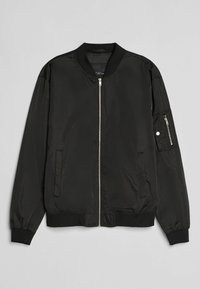 Svart bomberjacka med dragkedja fram, ribbade muddar och nederkant, sidofickor och en extra ficka med dragkedja på vänster ärm.