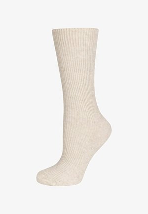 Cream-colored ribbed knee-high sock with a smooth texture and reinforced toe, featuring a classic design for everyday wear.