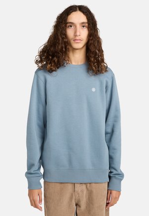 Light blue sweatshirt made of soft fabric, featuring ribbed cuffs and hem, with a small embroidered logo on the chest.