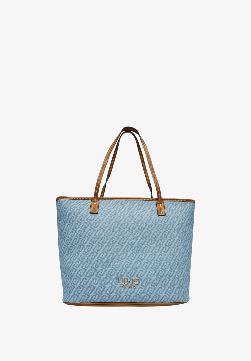 Sac fourre-tout bleu clair avec un motif tourbillonnant, poignées en cuir marron et bordure marron contrastante. Logo sur le devant. Design spacieux.