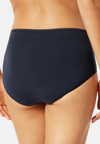 High-waisted navy blue cotton brief with a smooth texture and a seamless edge. Features a classic design for comfort and coverage.