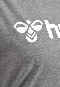 Grå bomulds t-shirt med en glat tekstur, prydet med et hvidt bi-logo og ordet "hub" i fed skrift.