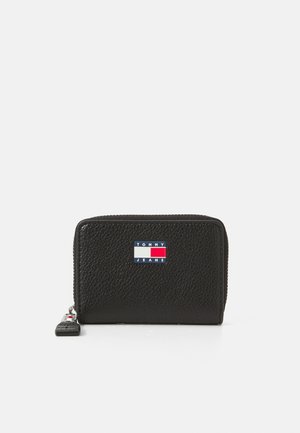 Black leather wallet with a textured finish. Features a rectangular shape and a colorful Tommy Jeans logo patch on the front.