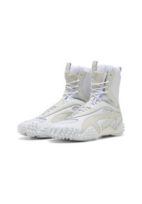 White high-top sneakers with a mixed-material upper, featuring smooth and textured panels, drawstring collar, and spiked rubber outsole.