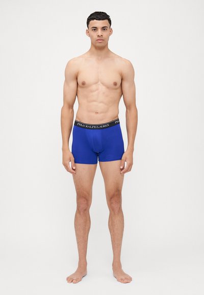 Boxer-briefs bleus en tissu lisse avec une ceinture élastique noire portant le logo "POLO RALPH LAUREN". Design ajusté.