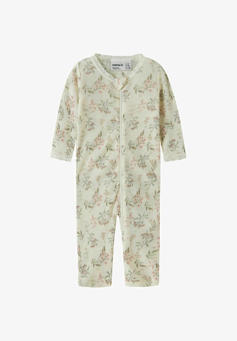 Barboteuse crème pour bébé avec imprimé floral rose et vert, manches longues, bordure en dentelle aux poignets et au col, et fermeture éclair frontale.