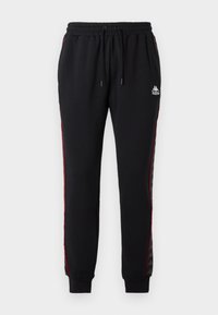 Pantalones de chándal negros con cintura elástica, franjas laterales rojas y logotipo de Kappa. Están hechos de un tejido suave, con puños acanalados y un corte relajado.