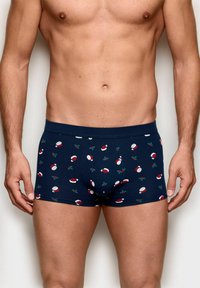 Marineblaue Boxershorts mit festlichem Muster aus roten Weihnachtsmannmützen und grünen Stechpalmenblättern, gefertigt aus weichem, dehnbarem Stoff.