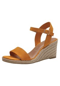 Sandale compensée en daim orange avec une large lanière au niveau des orteils et une lanière au niveau de la cheville avec boucle. Détails en corde de style espadrille sur le talon compensé.