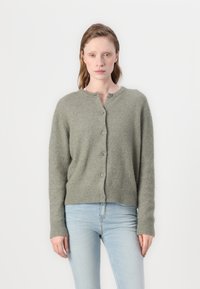 Green knit cardigan with a round neck, button closure, ribbed hem and cuffs. Soft texture, relaxed fit, and medium-length sleeves.