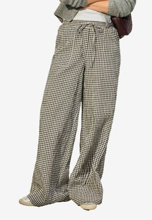 Pantalons à jambes larges en motif vichy noir et blanc, dotés d'une taille élastique avec cordon de serrage et de poches latérales. Tissu léger.