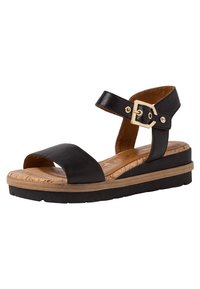 Black leather sandal with a wide strap, adjustable ankle buckle, cork insole, and a layered, textured sole for added comfort.