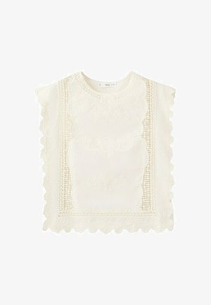 Bluza albă fără mâneci, cu modele complicate din dantelă și margini festonate pe față și pe părți.