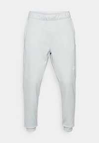 Svetlosivé tepláky vyrobené z mäkkého materiálu, s elastickým pásom, bočnými vreckami a zúženými manžetami. Minimalistický dizajn s detailom loga.
