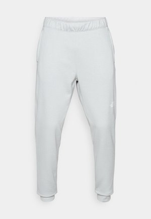 Pantaloni della tuta grigio chiaro realizzati in tessuto morbido, con vita elastica, tasche laterali e polsini affusolati. Design minimalista con dettaglio del logo.