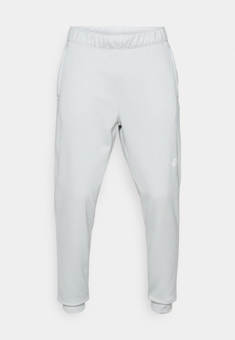 Pantalons de survêtement gris clair en tissu doux, dotés d'une taille élastique, de poches latérales et de poignets fuselés. Design minimaliste avec un détail de logo.