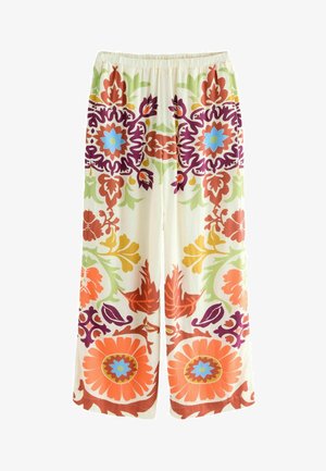 Floral patterned wide-leg trousers in light cream with vibrant orange, purple, green, and blue designs. Elastic waistband for comfort.