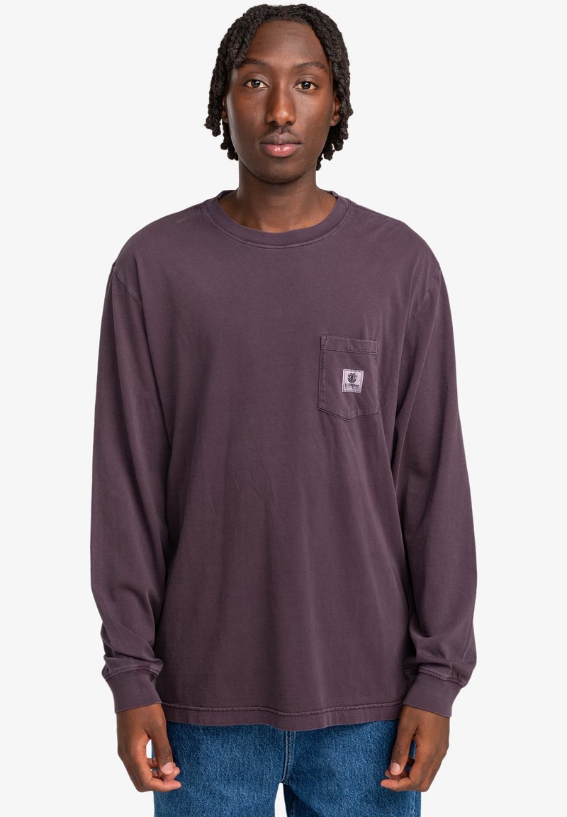 Long-sleeve purple cotton shirt with a chest pocket. Features a crew neckline and a relaxed fit, paired with blue denim jeans.