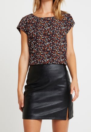 Floral short-sleeve top with black, navy, and orange pattern; paired with a black leather mini skirt featuring a side slit.