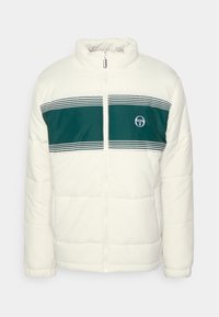 Pufferjakke i creme med en mørkegrøn vandret stripe, med lynlås og logo på brystet. Tekstureret, polstret stof.