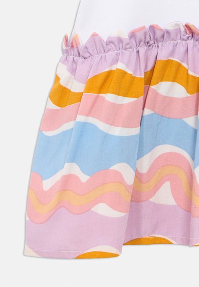 Χρωματιστό φόρεμα με λευκό τοπ και φούστα με πολύχρωμο κυματιστό μοτίβο σε ροζ, μπλε, κίτρινο και λεβάντα· λεπτομέρεια με βολάν στη μέση.