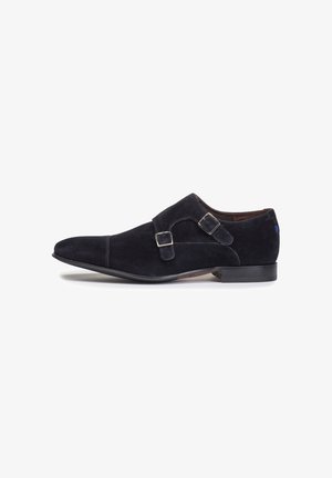 Suede double monk strap shoe in dark navy. Features a sleek pointed toe, adjustable metal buckles, and a smooth outsole for durability.