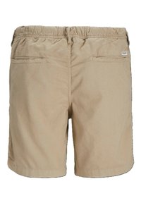 Pantalones cortos de algodón beige con una cinturilla elástica, dos bolsillos traseros y un sencillo detalle de costura. La tela tiene una textura suave.