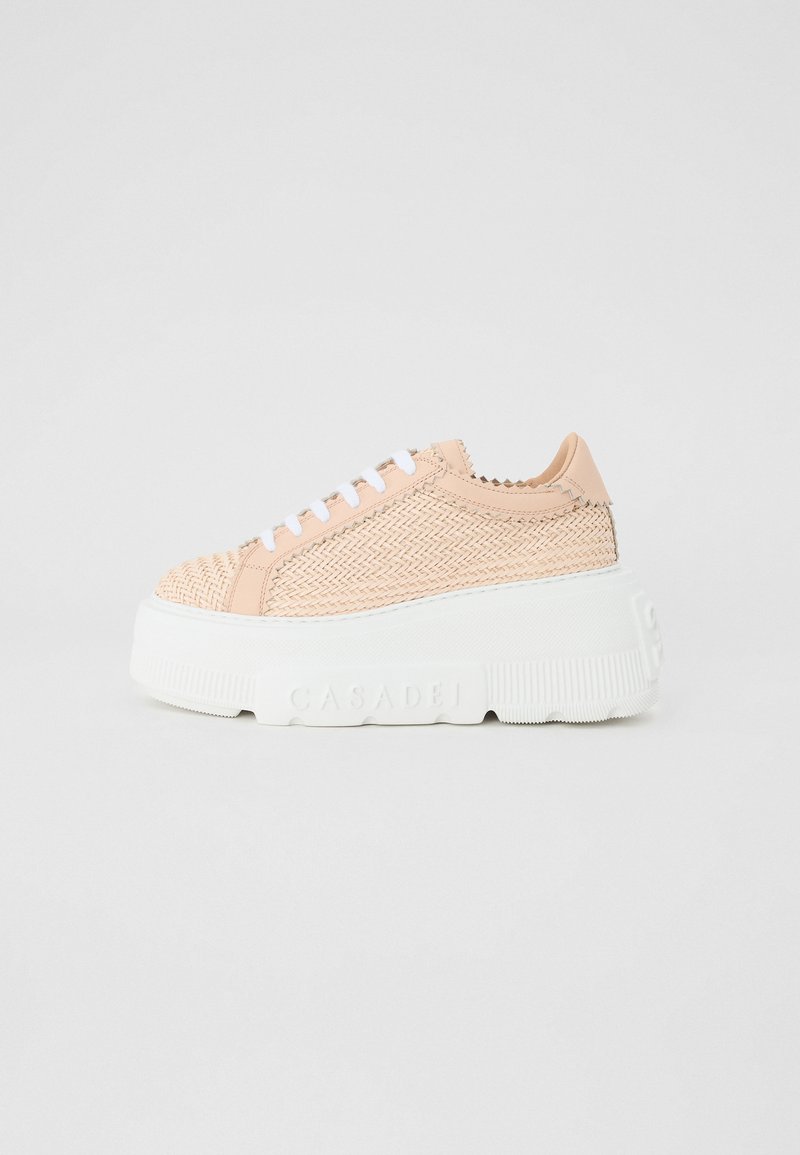 Basket shoes featuring a woven pink upper, white rubber platform sole, and lace closure. Textured materials and branding on the side.