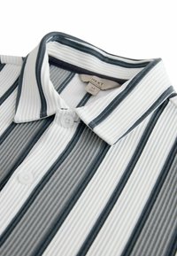 Striped polo shirt featuring alternating white, grey, and dark blue ribbed fabric, with a classic collar and button closure.