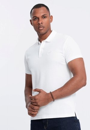 Hvid kortærmet polo-shirt i bomuld med et diskret broderet logo på brystet, med lige snit og sideslids.