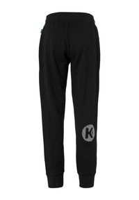 Sorte sweatpants med et struktureret design, elastisk talje og et rundt logo med bogstavet 'K' i et maskelignende mønster på venstre ben.