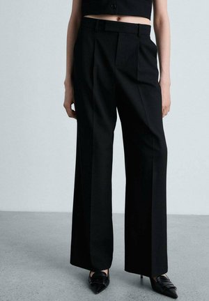 Black wide-leg trousers with pleats, made from smooth fabric. Features a tailored fit, flat front, and crisp crease down the legs.