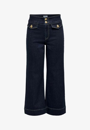 Jean large à jambes larges de couleur bleu foncé avec taille haute, deux boutons dorés et deux petites poches à rabat avec boutons dorés à l'avant.