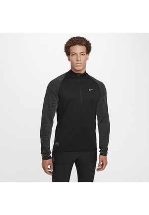 Schwarz langärmliges Sportoberteil mit einem Halb-Reißverschluss an der Vorderseite, mit einem strukturierten Streifenmuster an den Ärmeln und dem Nike-Logo auf der Brust.