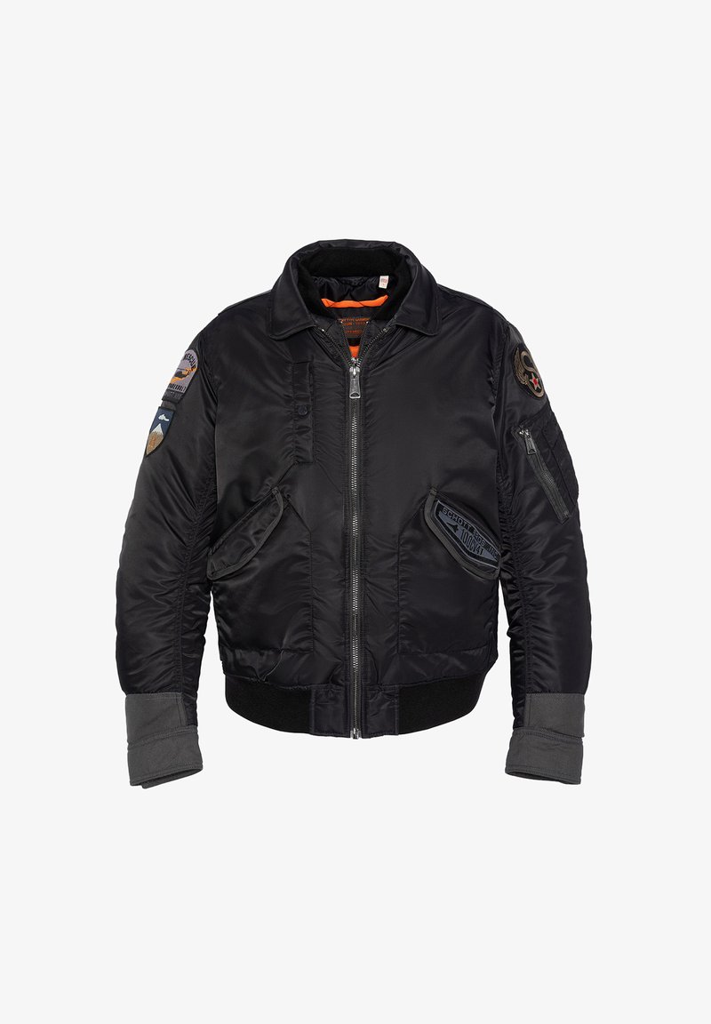 Giacca bomber nera in nylon liscio, con polsini e orlo a costine, diverse toppe e chiusura con zip frontale, oltre a due tasche laterali.