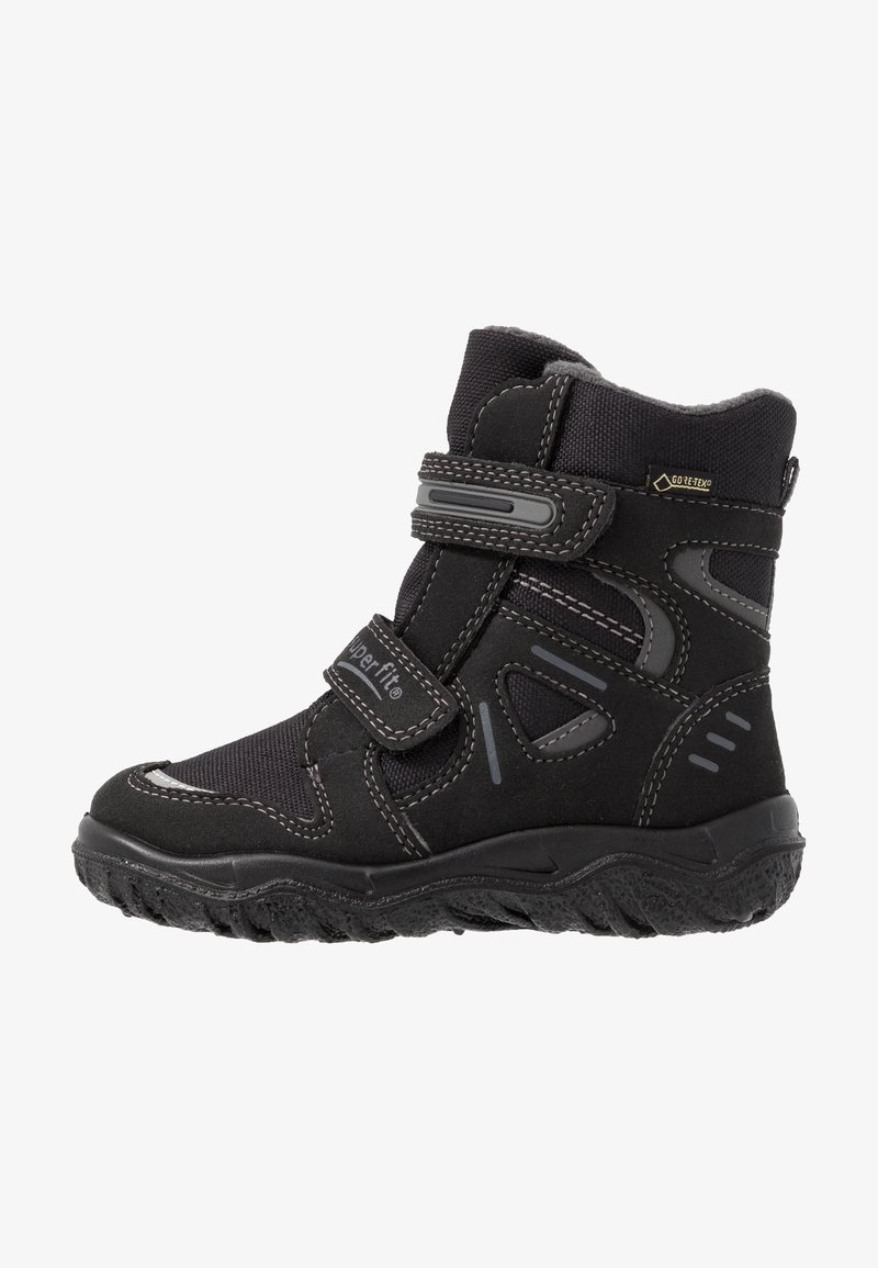 Botte d'hiver noire pour enfant avec double bandes Velcro, semelle renforcée, étiquette Gore-Tex et maintien de cheville rembourré pour une utilisation imperméable.